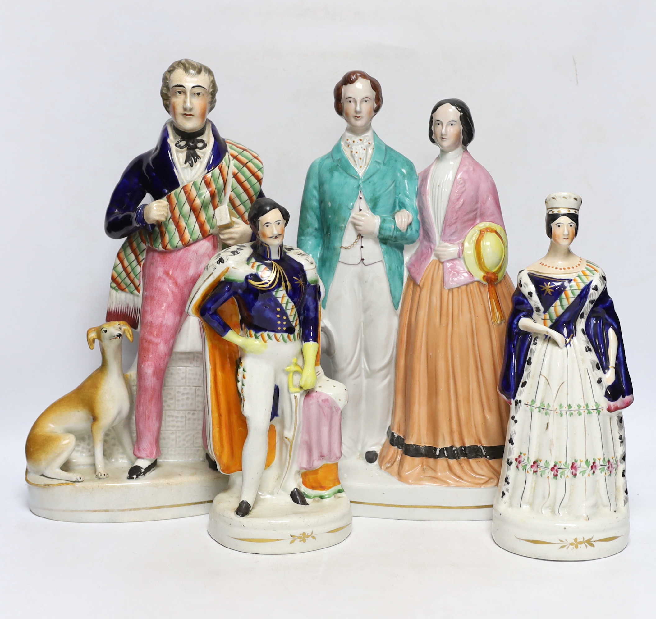 Four mid 19th century Staffordshire figure groups including Queen Victoria and Prince Albert, two individual figures of the Queen and Prince and Sir Walter Scott, tallest 36cm high
